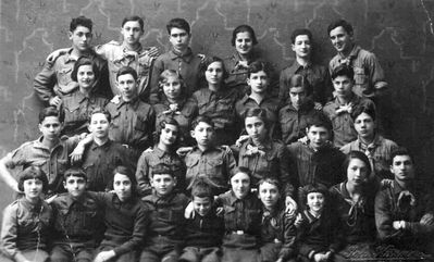1933-4-25 - Narva Hashomer with "madrichim"
Top row: Zemach Schapiro, Isi Goldmann, Jossi Mesnikov, Aharon Zechovoi, Lika Schampal, Mischa Zimbalov, Monja Schmotkin
II row: Lena Rutstein, Sika Baran, Sonja Maslovski, Bluma Geruchmanov (Stein), Rolka Zimbalov, Hiti Girman, Isi (Isak) Haitin,
III row: ?, Abram Kulman, Rimma Zimbalov, Aron Maslovski, Bluma Schapiro, ?, Dov Maisel
Bottom row: Lena Rosenberg, Faiva Schapiro, Selda Harhat, Dora Zagorje, Leva Zagorje, Ditta Rosenberg, Dina Danzig, Alter Zimbalov
