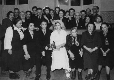 Raichmann Harry mariage in synagogue - 1955
Left to right.
First row: ?, Deborah Bam (Rybak) from Riga, Harry Raichman, Ida Raichmann (Bam), Taube Bam, Sina Sverdlov, ?
Standing: ?, ?, ?, ?, ? (all relatives from Riga), Rafael Bam, Eda Bam, Haja Judeikin (Raichmann), Rina Hecht (Bam), Raja Bam (Koslovski), Boruch Bam with Deborah Bam, Bere Raichmann, Zion Bam, Isi Raichman, Leo (Arie) Raichmann 
