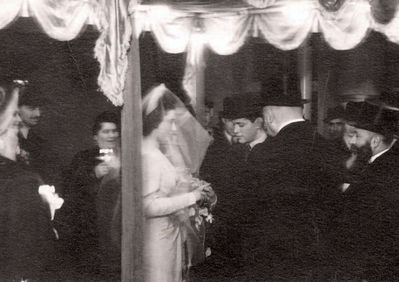 Koslovski wedding - December 1940
This is the wedding photograph of my [Rachel Randvee] sister Riva Koslovski, nee Tsivian. It was taken in Tallinn in 1940.
My sister married in December 1940. Her husband, Yakov Koslovski, also graduated from the Jewish school albeit four years earlier than Riva. Their wedding was quite modest with only close friends and relatives present. Some arrests and nationalization of property had already
taken place in Tallinn by that time so it wasn't really a very joyful time. Meishe Furmanski, Aunt Rasse's husband, died just before the wedding, the funeral was held on the wedding day, and many of the relatives were attending that event. The wedding ceremony took place in the synagogue's registry office and was conducted by Aba Gomer, the chief rabbi of Estonia.
Keywords: [Religion]