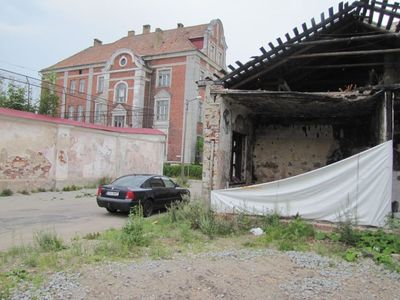 Stone building of the synagogue (offices), hospital building to the left and the prison in front of it. 2013.
The hospital supplied sweetened porridge to the children kept in the synagogue in 1941. After eating it, the children were dead. This was told by a man that worked in that hospital in 1941.
